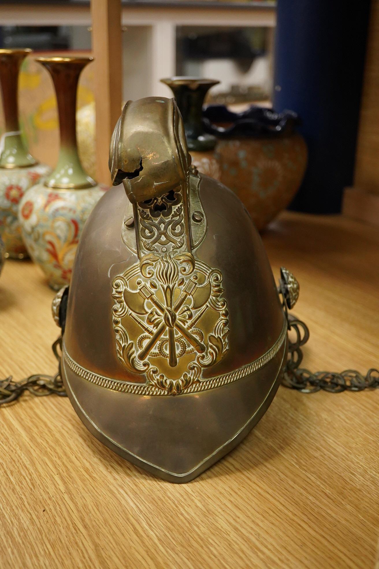 A 20th century theatrical British Metropolitan brass fireman’s helmet, 21cm high